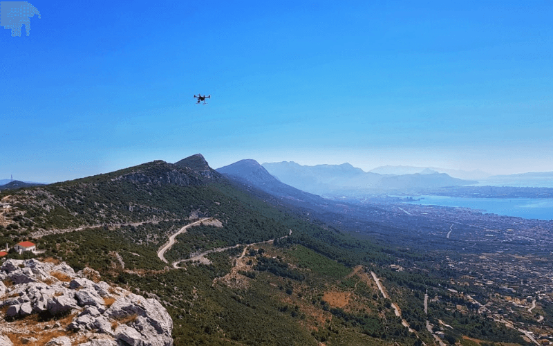 A drone in the sky above mountains
