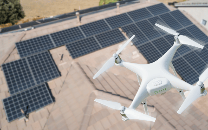 A drone hovering over solar panels